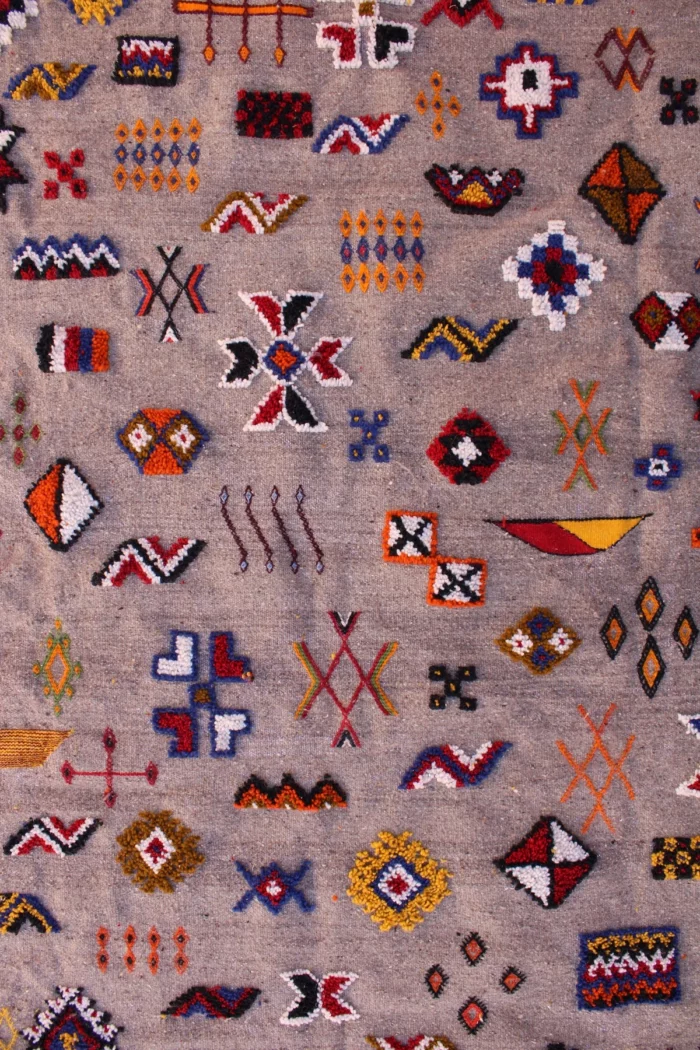 Unique Moroccan rug featuring a fusion of patterns and colors
