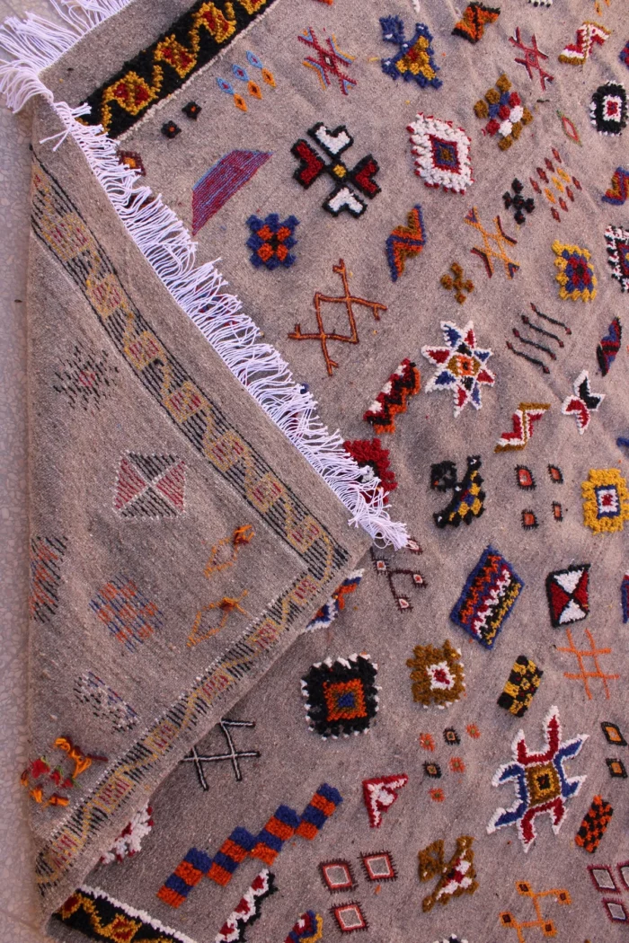 Unique Moroccan rug featuring a fusion of patterns and colors