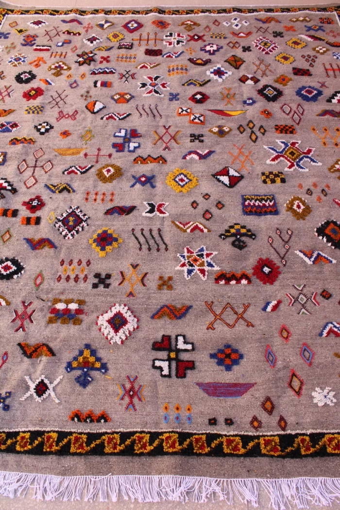 Unique Moroccan rug featuring a fusion of patterns and colors