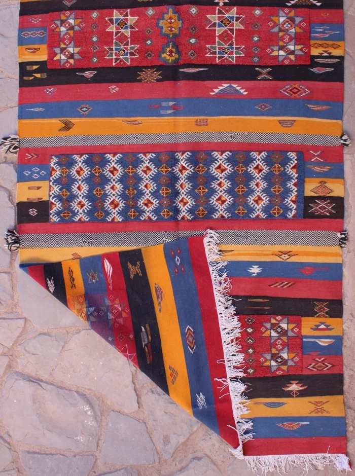 Handwoven Moroccan rug featuring traditional Berber patterns and vibrant colors